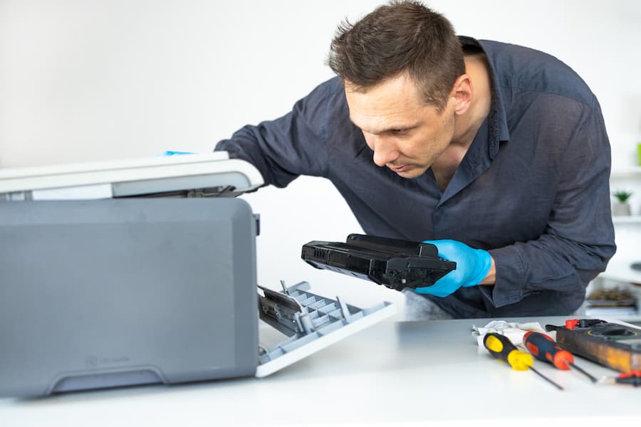 Technician replacing a toner cartridge during a service call